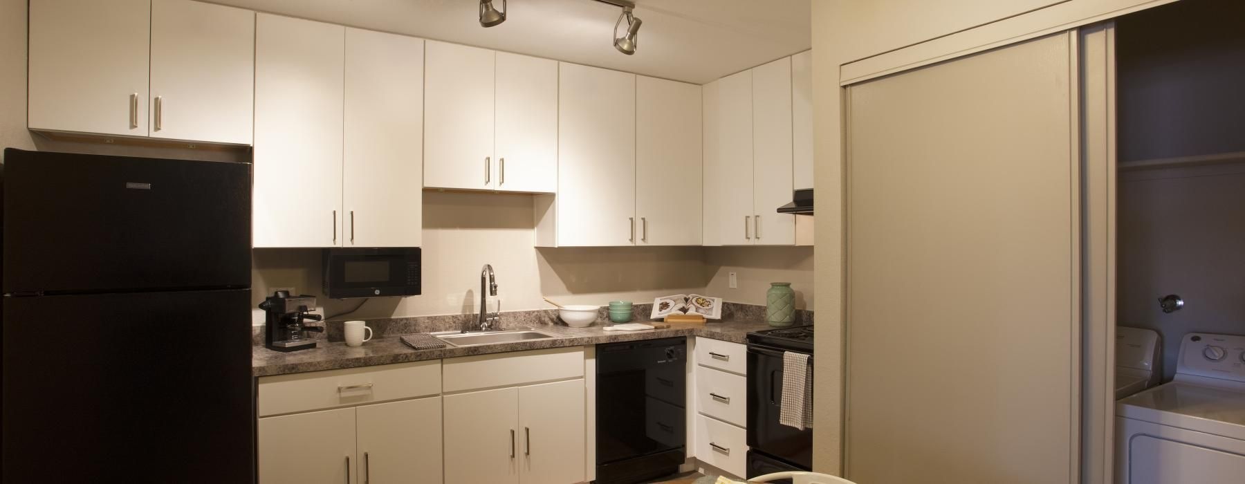 a kitchen with white cabinets
