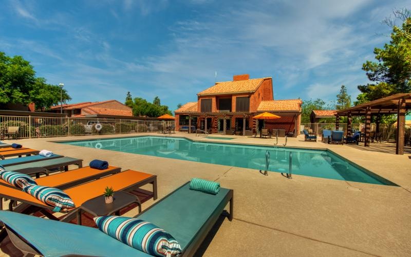 a swimming pool with lounge chairs