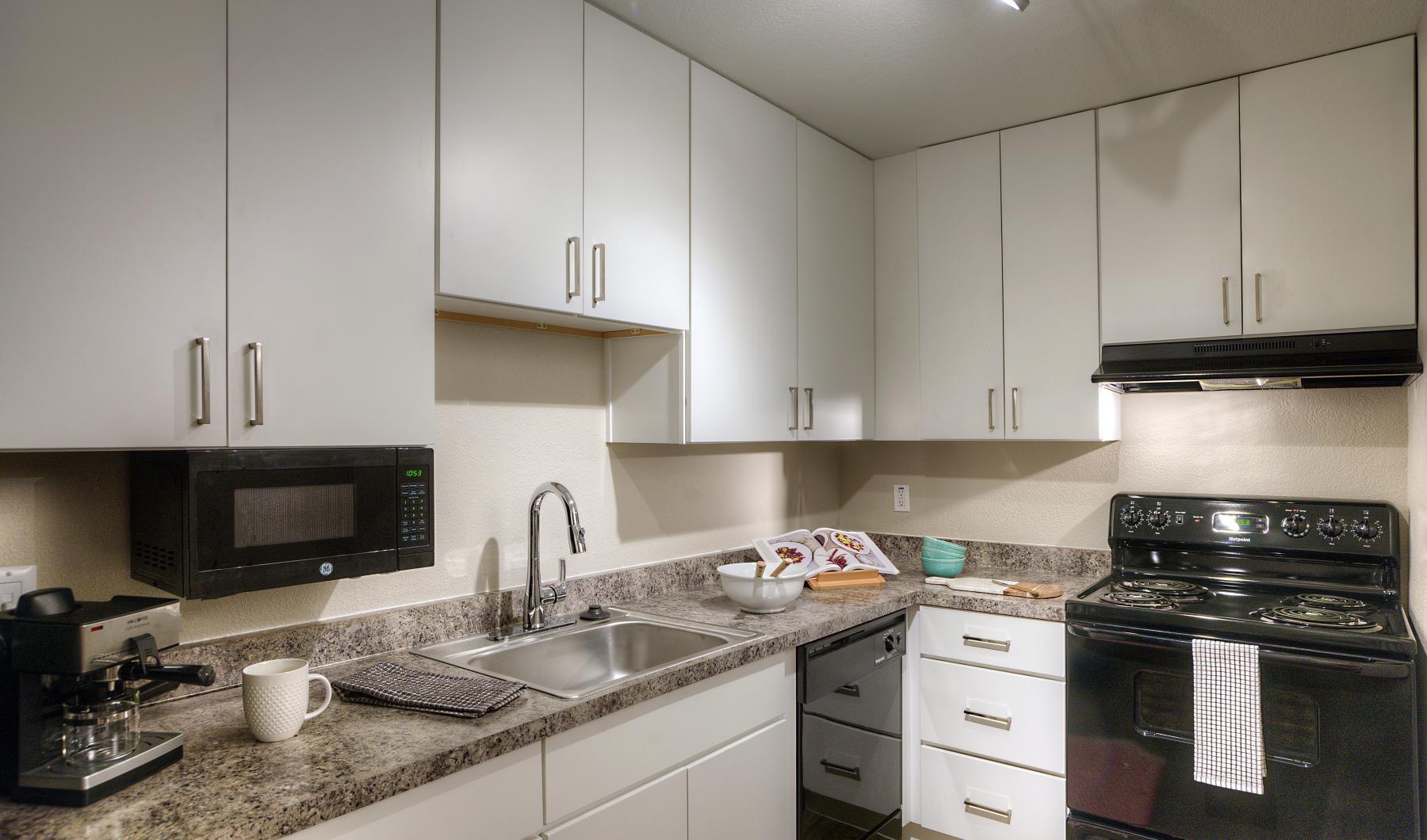 a kitchen with grey cabinets